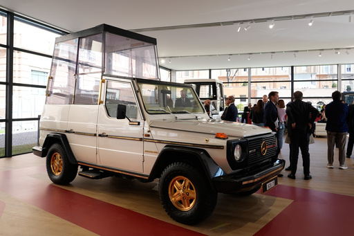 A popemobile exhibition is unveiled at the Vatican, featuring the vehicle popes have used since 1930